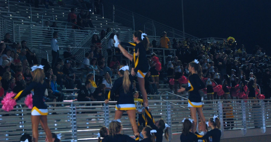 cheerleaders perform at a football game