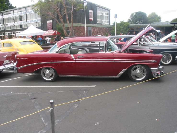 old cars sit in the parking lot next to each other