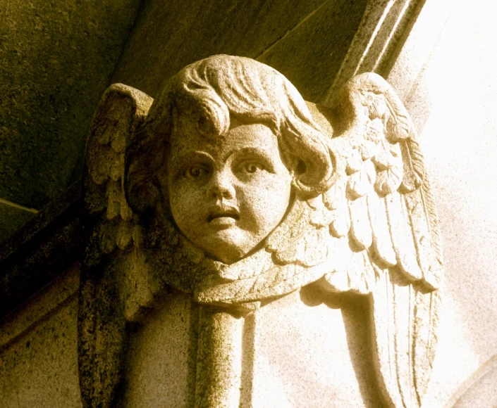 an angel - like head on the corner of a building