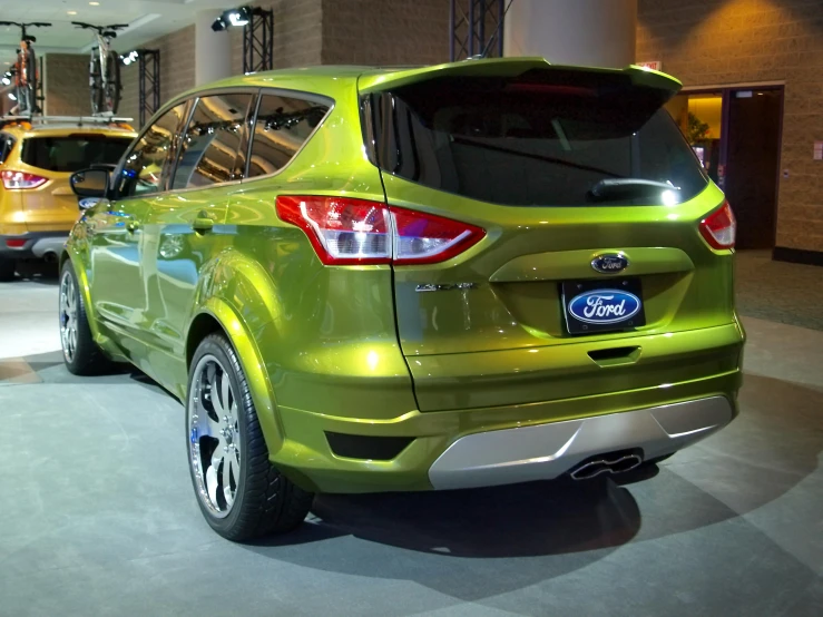 a car parked in a room with other cars on display