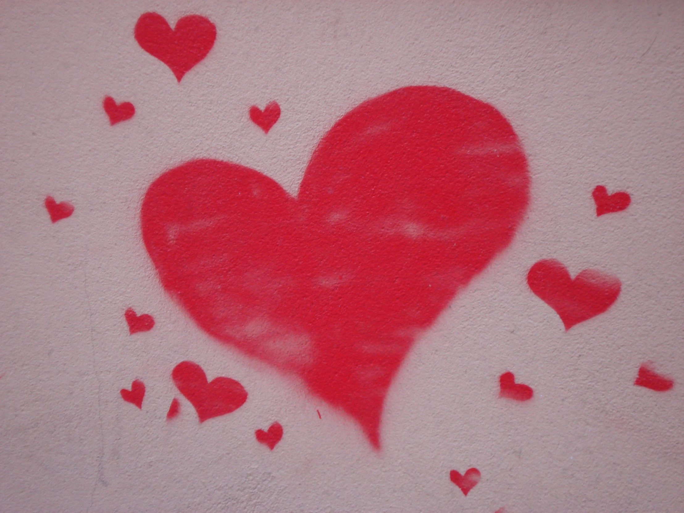 a red painted heart with small hearts scattered on it