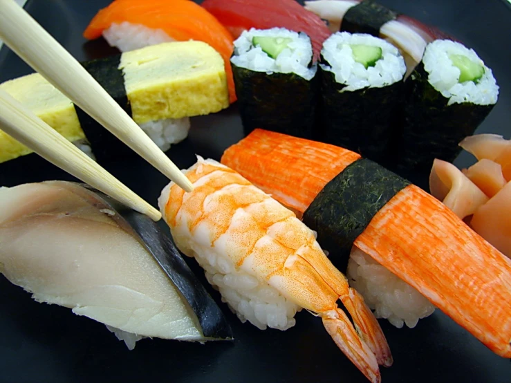 there is a plate with different kinds of sushi