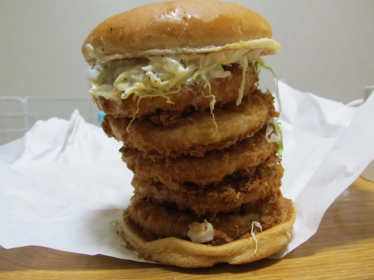 a tall stack of chicken nuggies sitting on top of a table