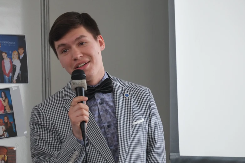 a man in a suit holding a microphone