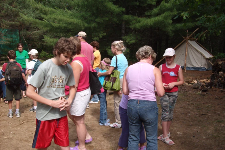 a group of people gather around a campfire