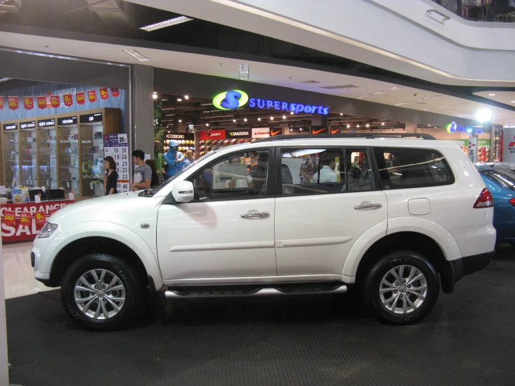 a white suv is parked in a mall