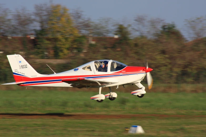 a single propeller plane taking off on the runway