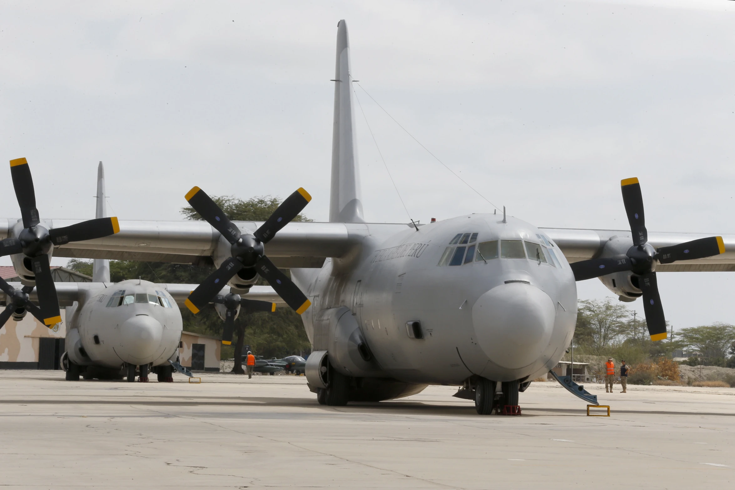 two large white airplanes are parked next to each other