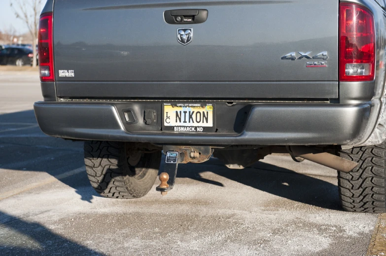 a gray truck parked on the side of a parking lot