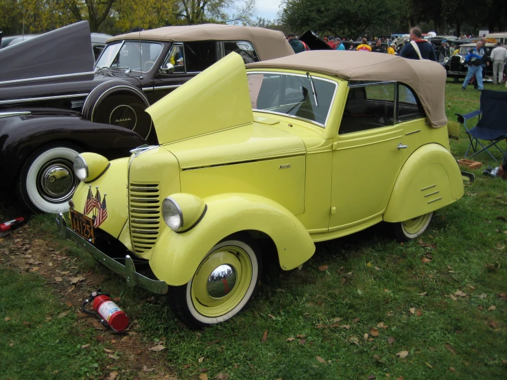 the old cars have been parked on the grass