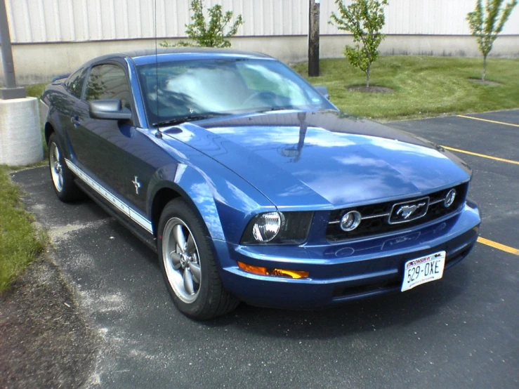 there is a blue car parked in the lot