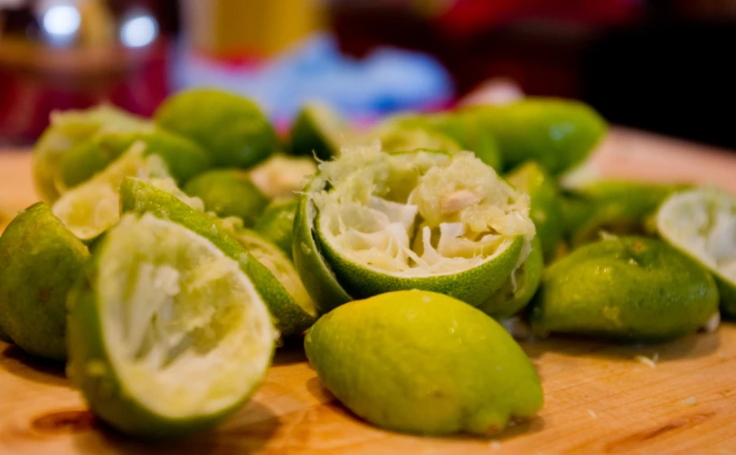 limes cut into half with a knife next to them
