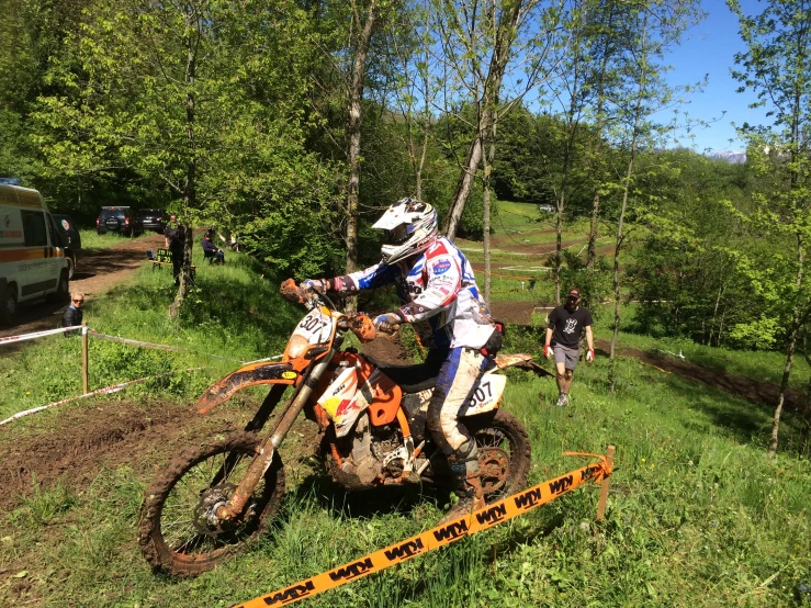 two people on dirt bikes riding down a trail