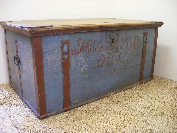 a vintage style blue trunk with rusted leather trim