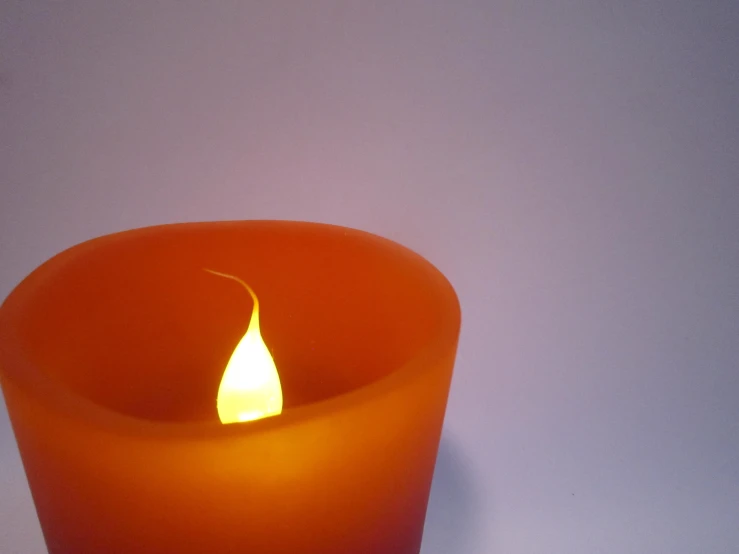 a candle that has been turned yellow into the flame