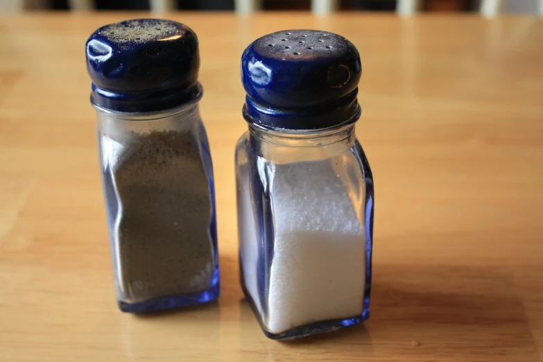 two salt and pepper shakers on a table
