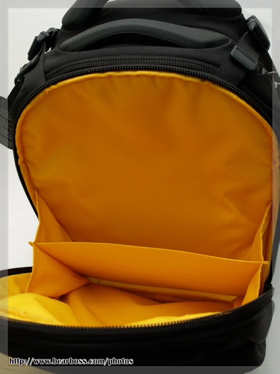 a yellow and black back pack filled with clothing