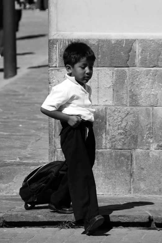 a  standing on the sidewalk in his pants