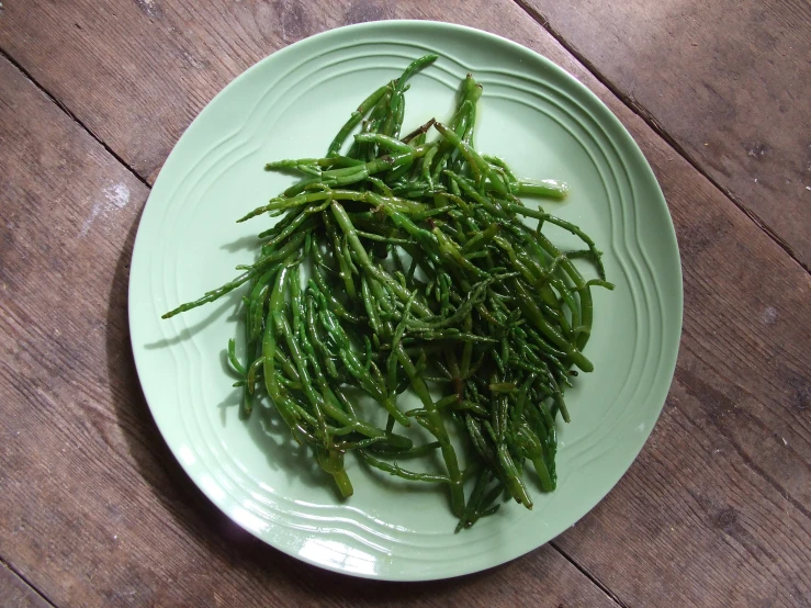 the plate of green beans sits on the table