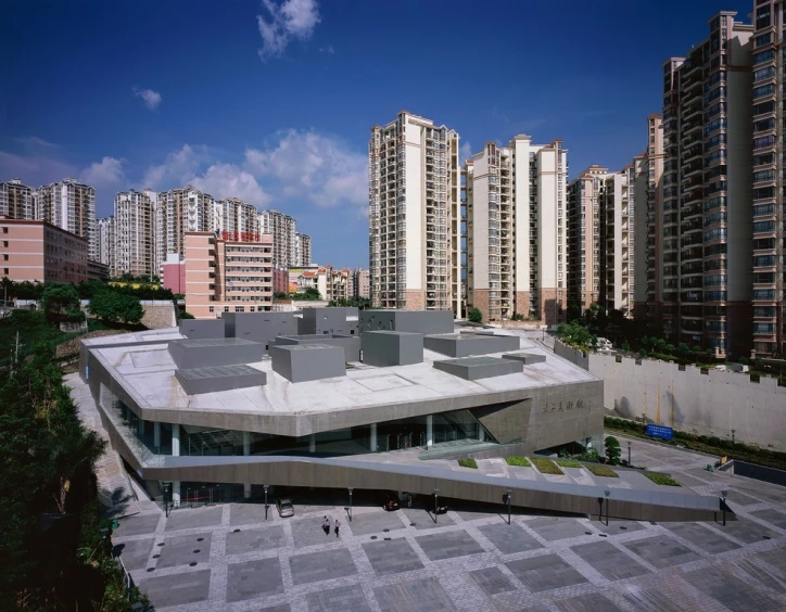 a large building in the middle of a big city with tall buildings around