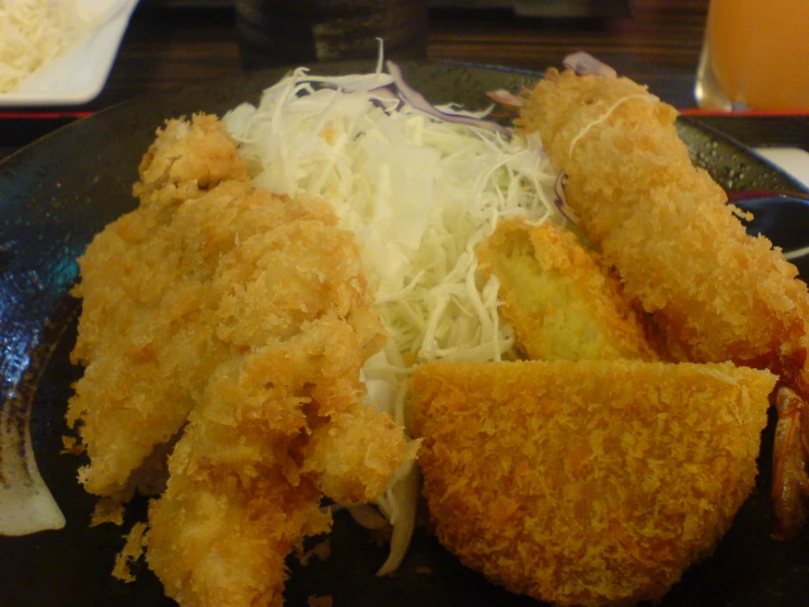deep fried seafood is served with an apple slaw