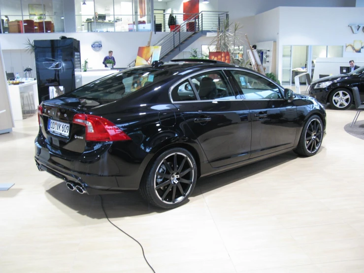 a black car parked inside of a building