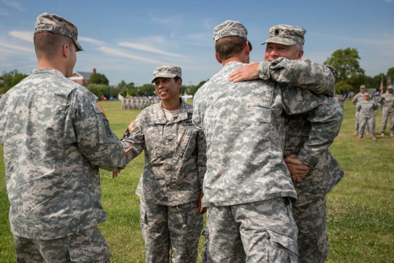 four soldiers in fatigues are gathered together