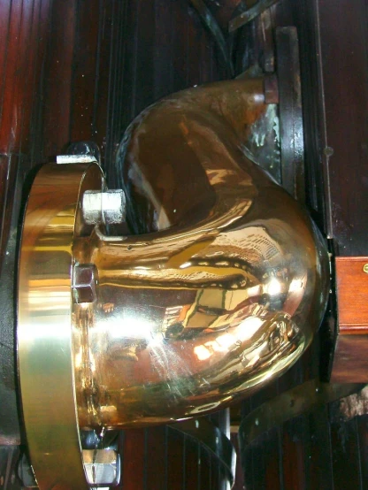 the back side of a close up of a gold object