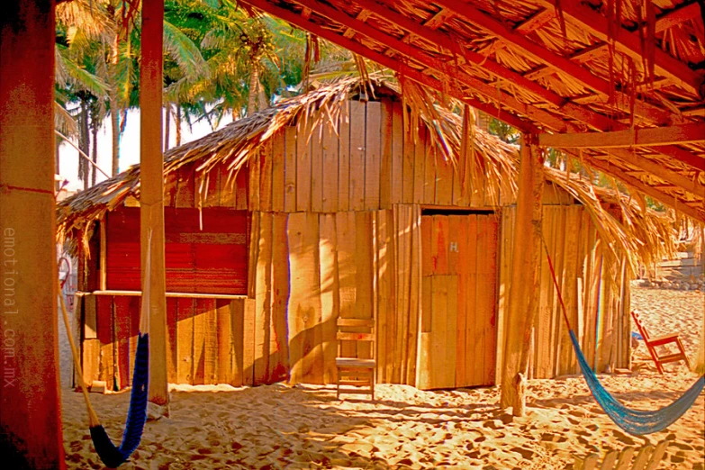 a hammock and rope are around a beach shack