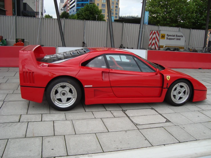 a red sports car parked on the side of a street