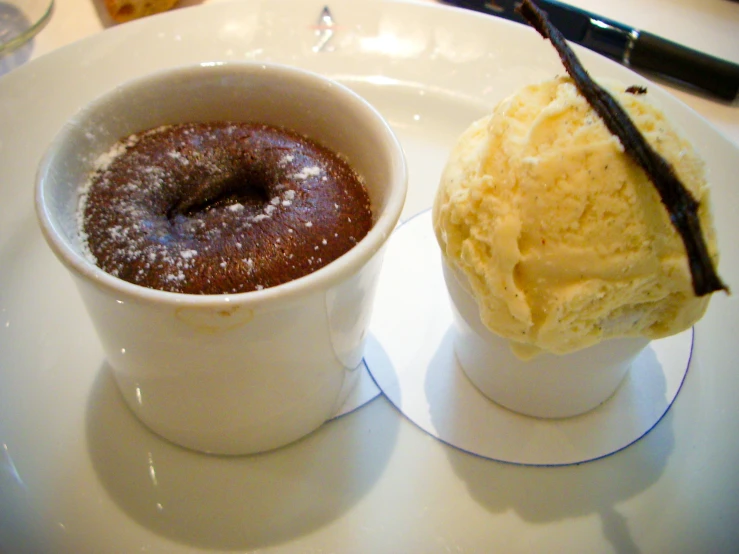 a cup of ding on a plate and some ice cream