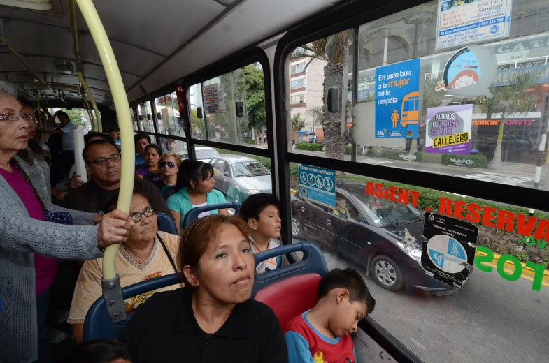 group of people standing and waiting on a bus