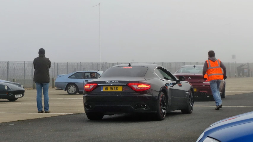 a number of cars driving in a parking lot