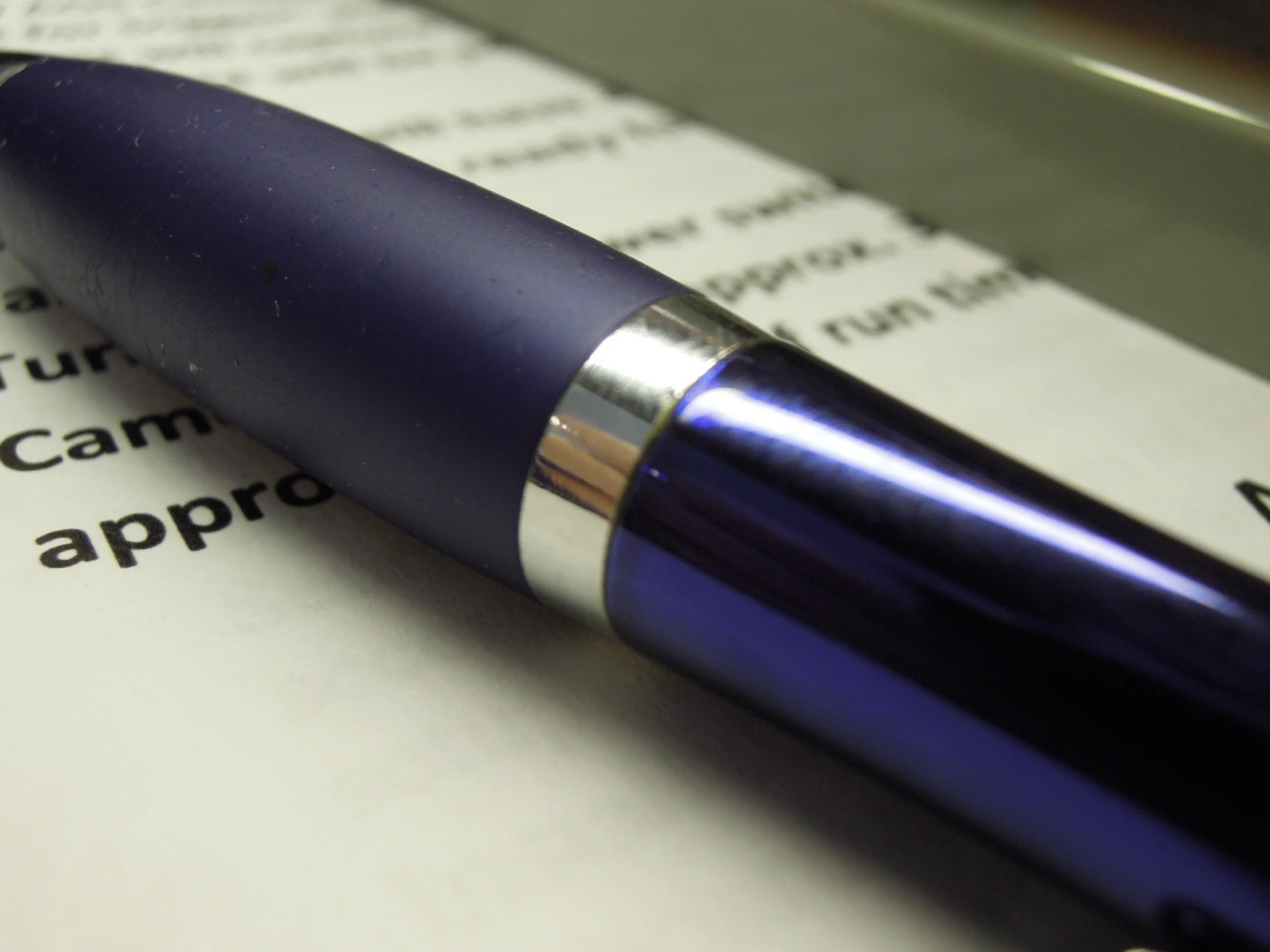 closeup of a blue pen on top of a document