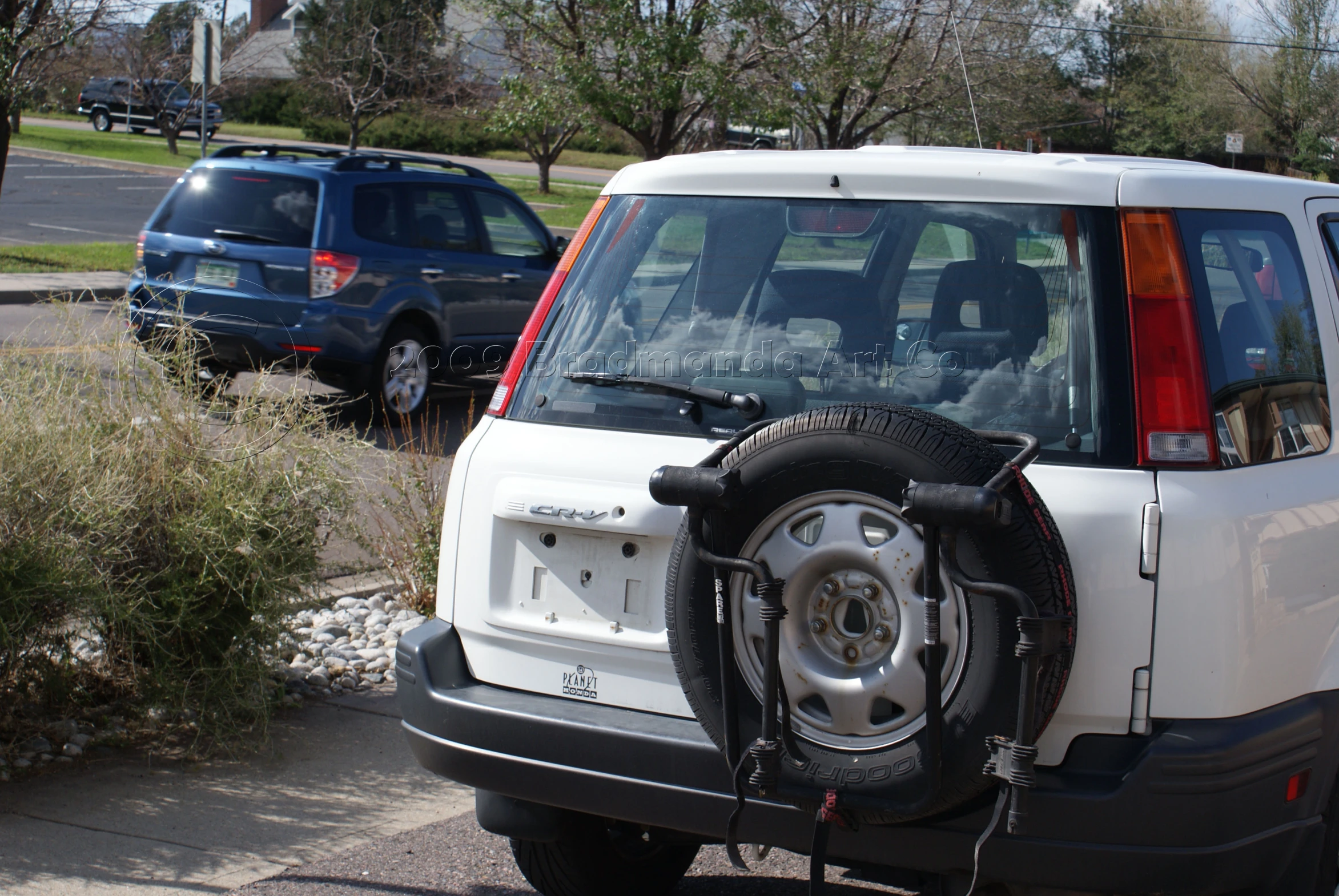 the front end of a white four - doored car