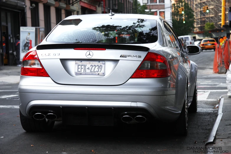 a mercedes with a chrome license plate is parked