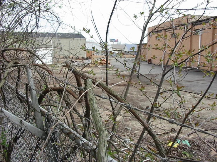 an old fence near a parking lot in the daytime