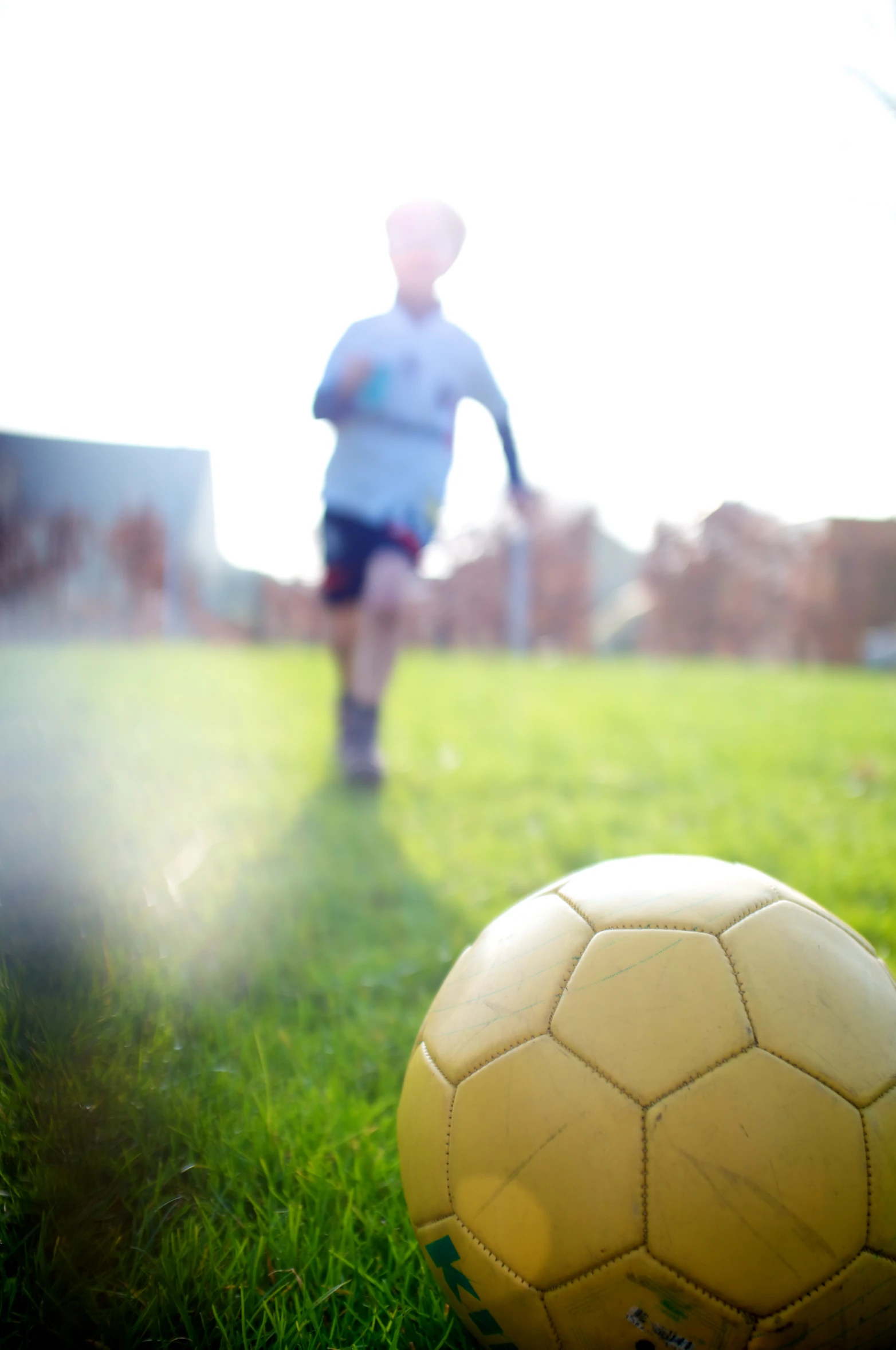 a soccer ball and a man in a blue shirt