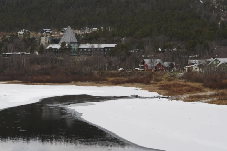 a river with ice covered water next to a city