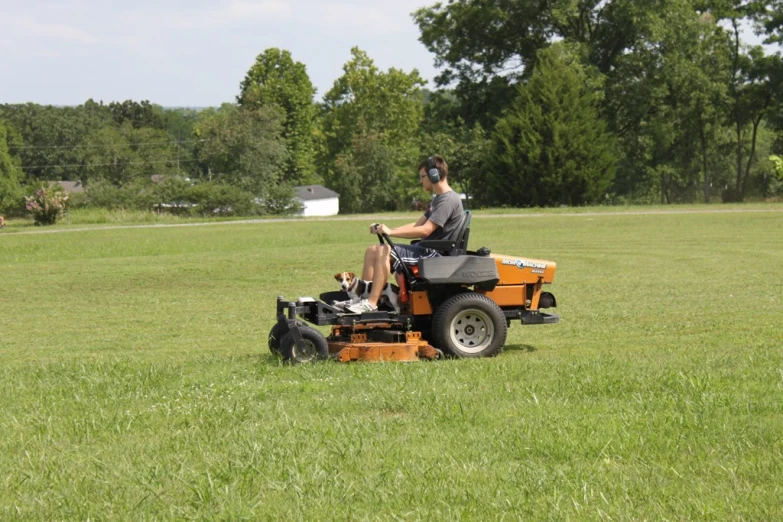 a man mowing the grass on his lawn