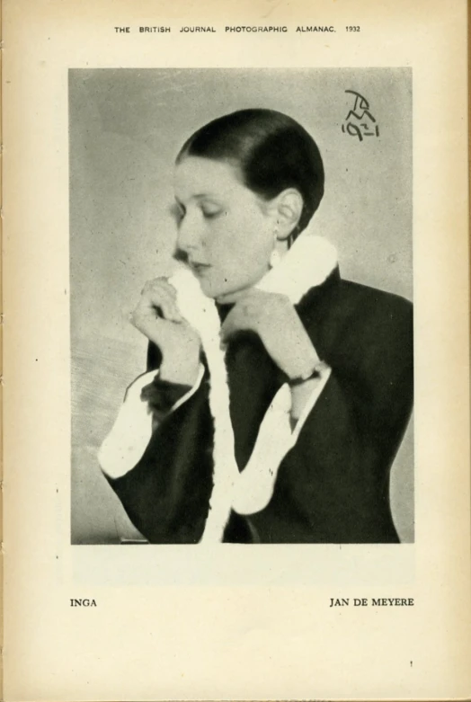 a woman with her finger on her thumb in an old black and white po