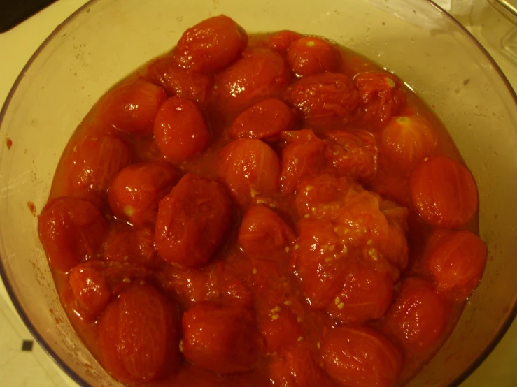 a pot full of red tomato sauce sits on a stove