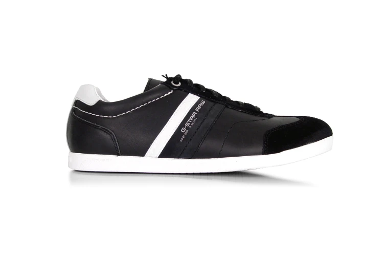 a black and white sneaker with a striped heel