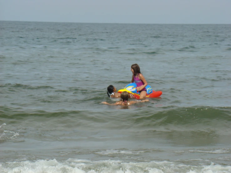 a woman in the ocean with a boy