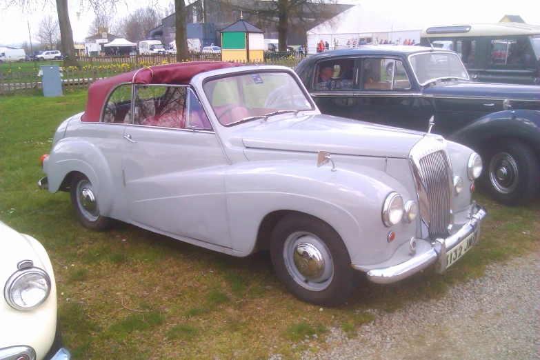 several classic cars are on display in an exhibition