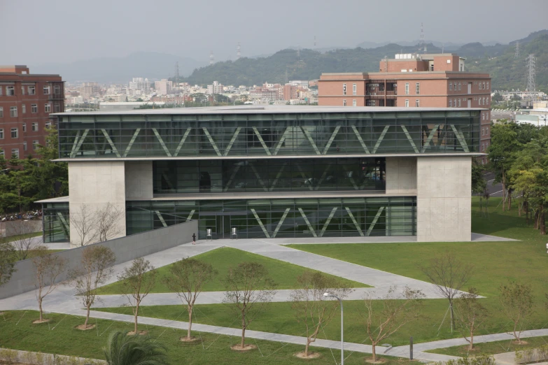 a building surrounded by a green grassy area in a city