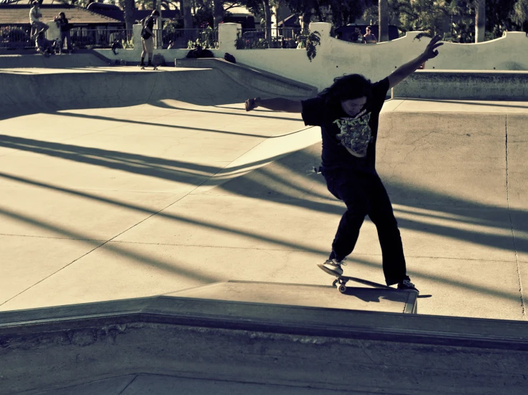 the boy is riding his skateboard in the skate park