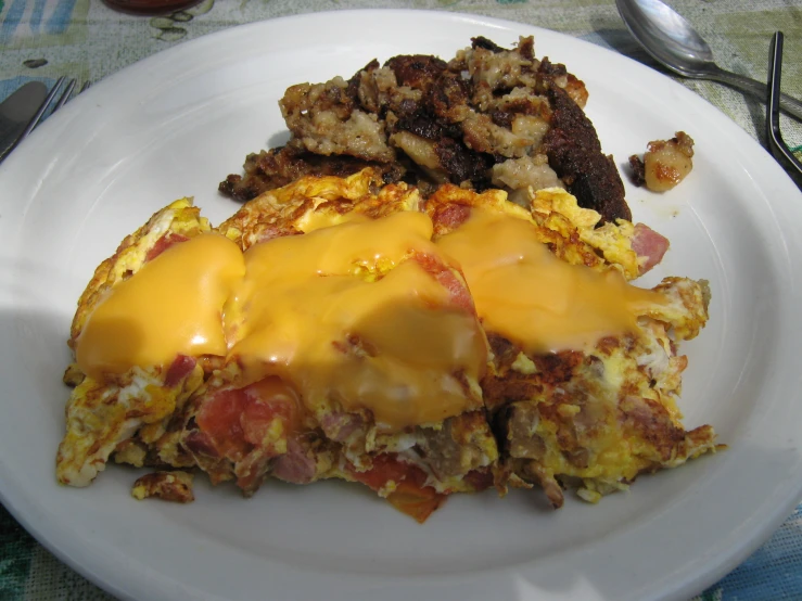 a plate has eggs, bacon and cheese on it