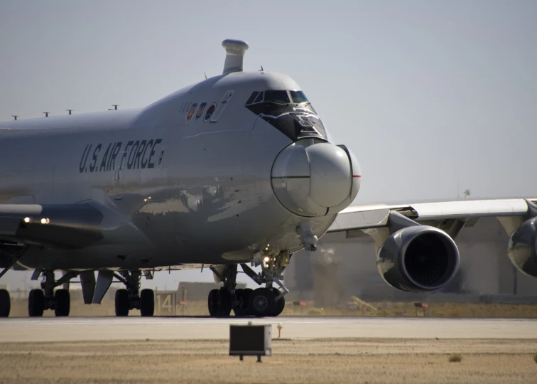 a plane sits on the runway at an airport