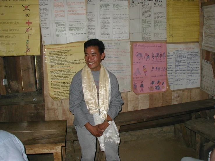 a man standing in front of a wall with notes on it